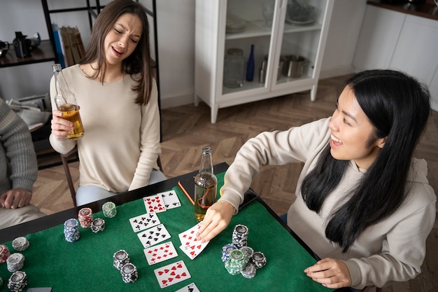 Photo friends having fun while playing poker