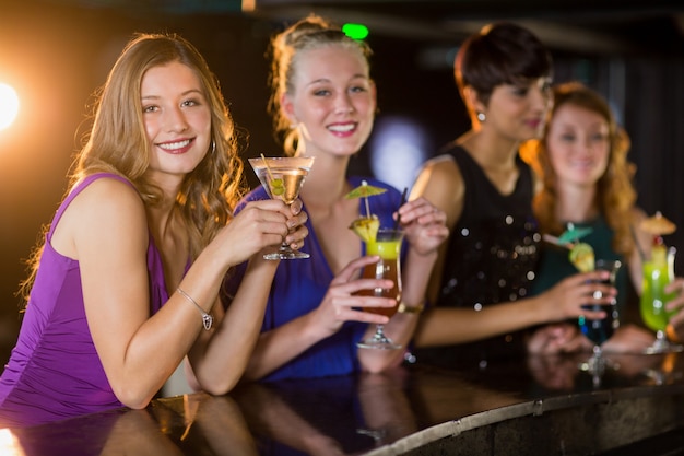 Friends having glass of cocktail in bar