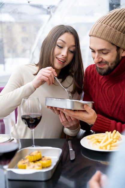 Friends having lunch together with wine after reuniting