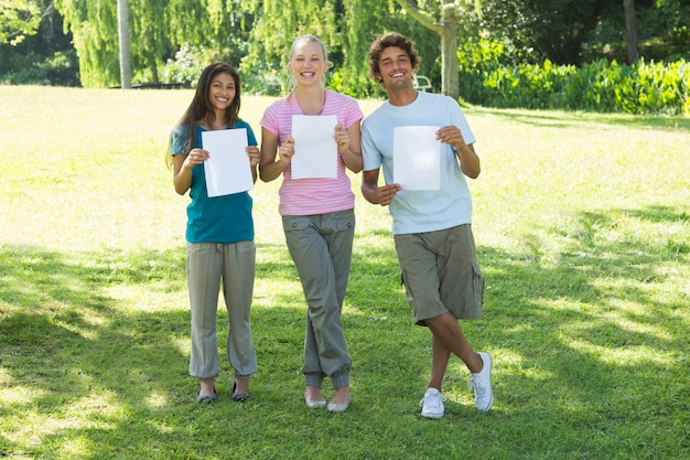 Friends holding blank papers