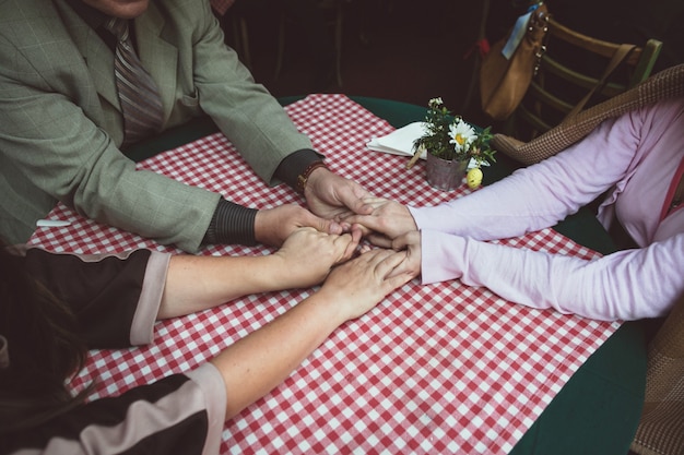 Friends holding hands in a bar