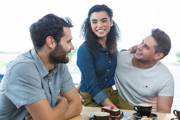 Friends interacting with each other in coffee shop