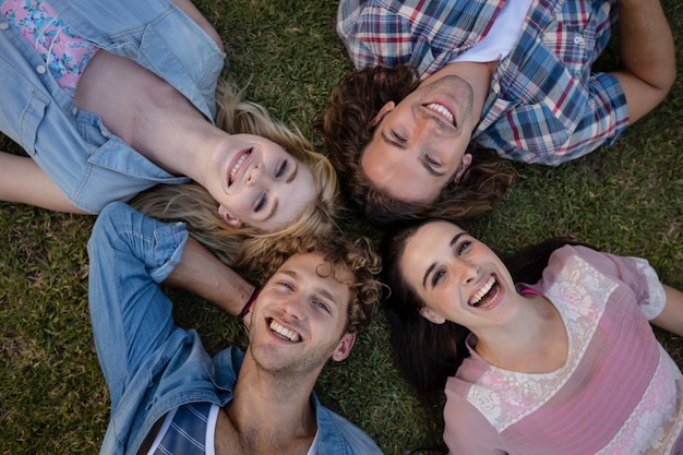 Friends lying on grass