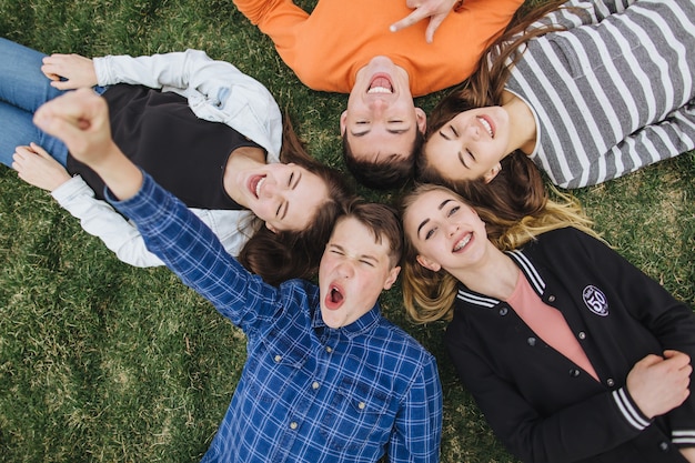 friends lying on the grass