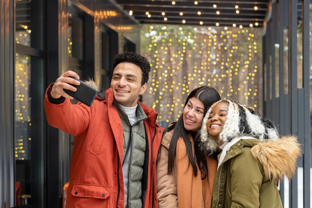 Friends making selfie portrait outdoors