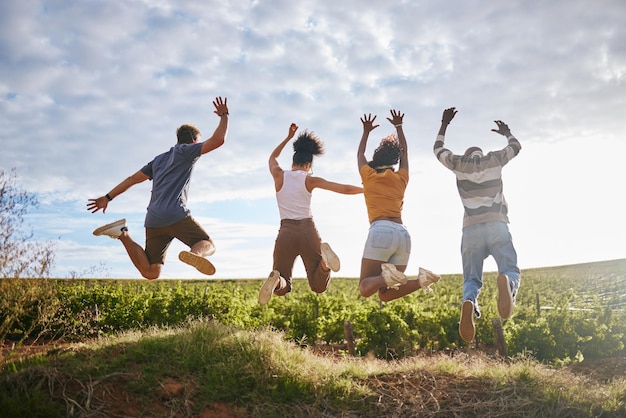 Friends nature and jumping for freedom in the countryside for summer vacation together in the outdoors Group of free people enjoying holiday break or travel in joyful fun outside in South Africa