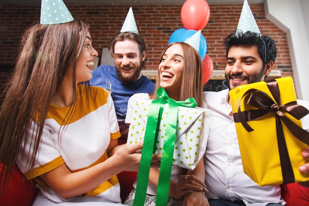 Friends offering gifts to amazing woman