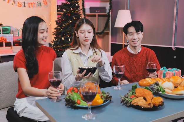 Friends opening Christmas gifts in living room