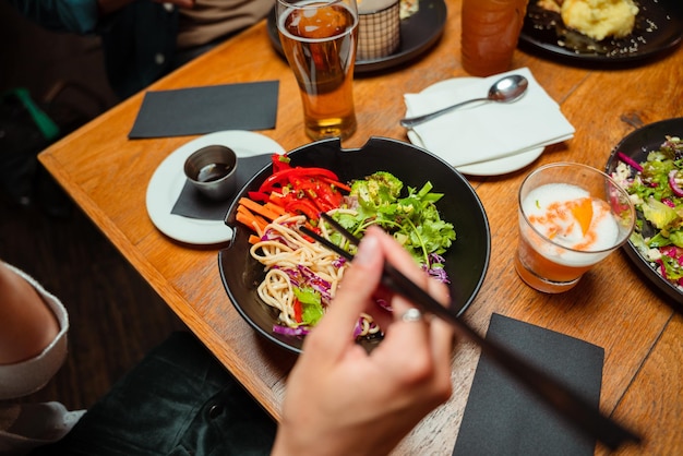 Friends out for dinner eating poke bowl