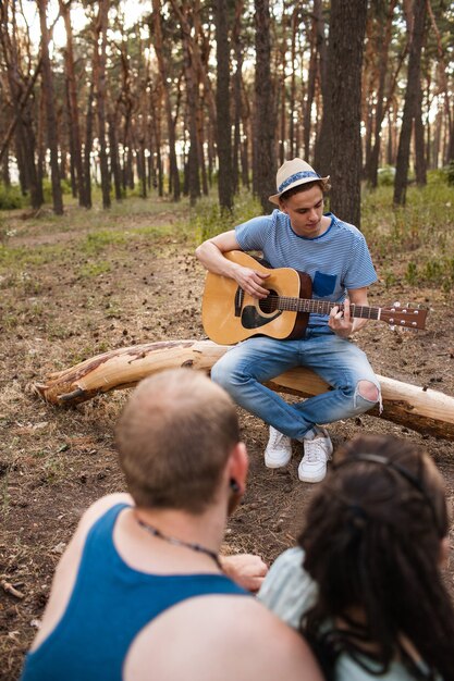 Friends picnic guitar music nature concept. Traveler lifestyle. Hiking happy moments.