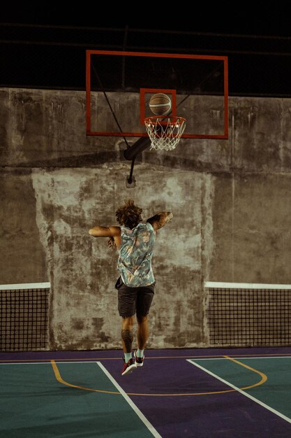 Friends play basketball. Young men play basketball in the street.