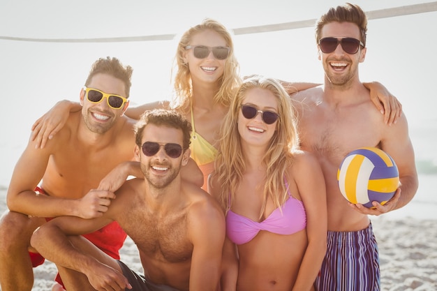 Friends playing beach volley