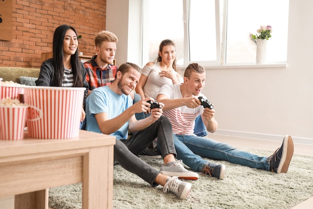 Friends playing video game at home