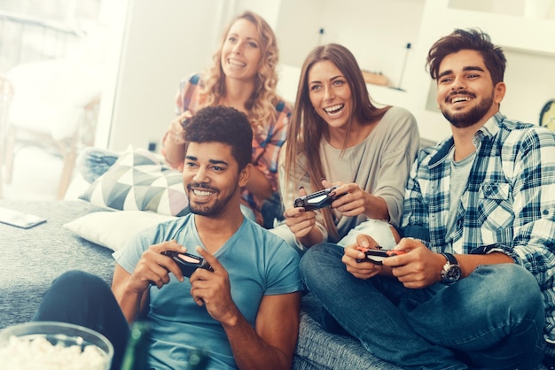 Friends playing video games at home