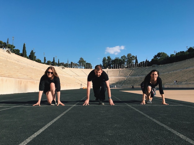 Photo friends poised on track at panathinaiko stadium