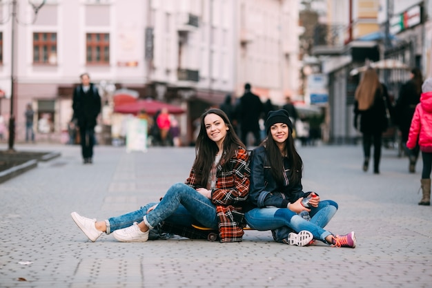 friends posing sitting on the street