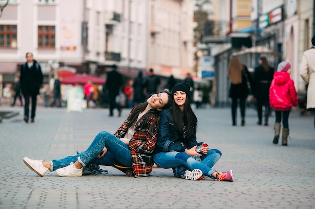 friends posing sitting on the street