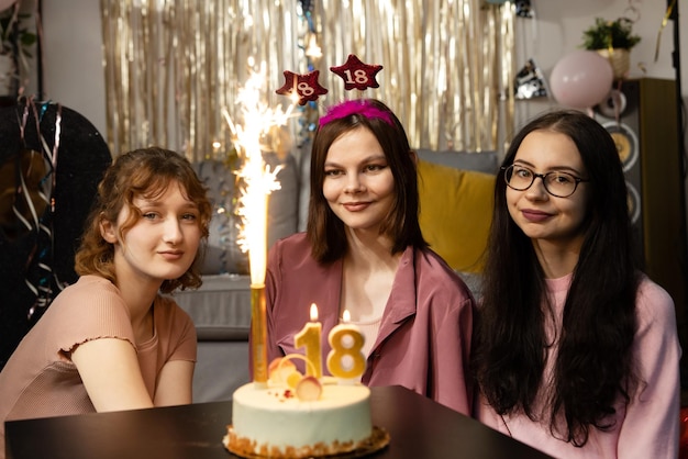 Friends presenting birthday cake to girl happy birthday to you