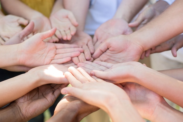 Friends putting their hands together 