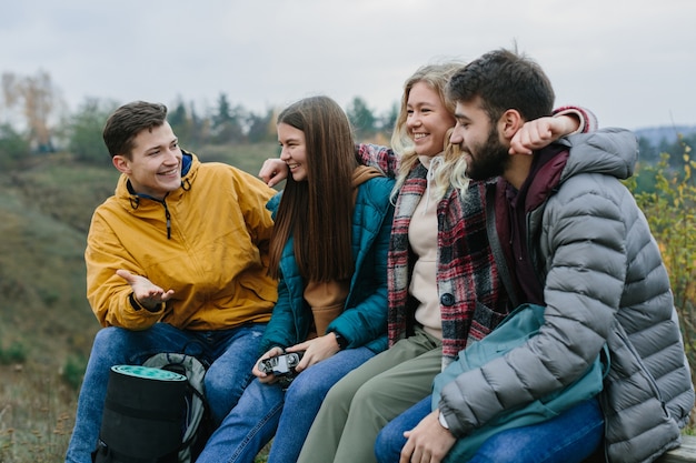 Photo friends relaxing on a bench in the mountains while climbing