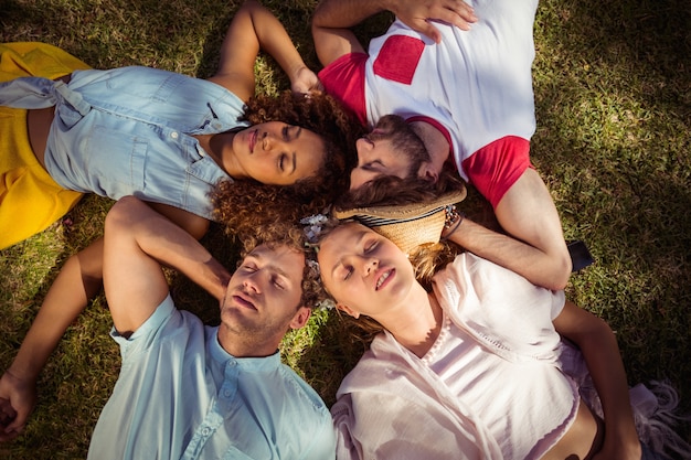 Friends relaxing on grass in park