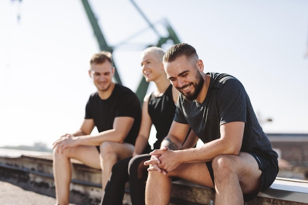 Friends resting after workout in ubran neighborhood Active lifestyle