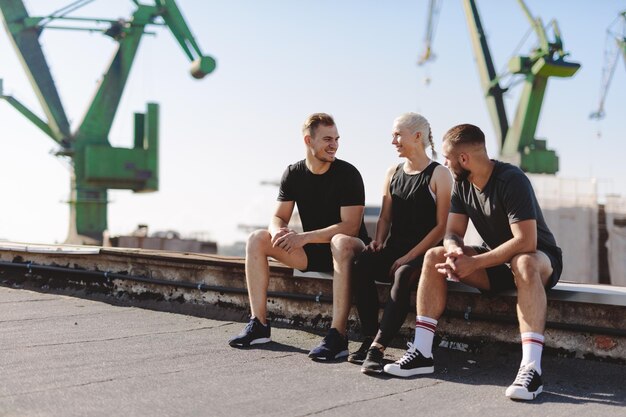 Friends resting after workout in ubran neighborhood Active lifestyle