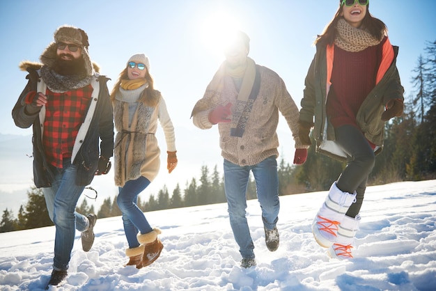 friends running on snow covered landscape