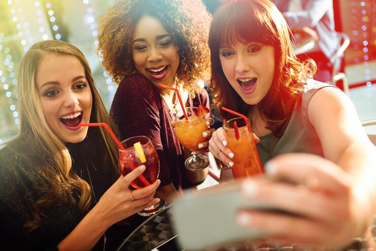 Photo friends selfie and face for clubbing party diversity and fun with alcohol or cocktails in club for entertainment smartphone happy and online for social media post technology and celebration