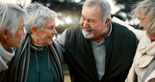 Friends senior people and outdoor talking with support in the park garden or conversation in nature with elderly man and women Happy together and group in retirement with quality time or speaking