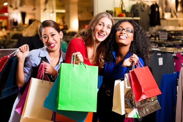 Friends shopping with presents in mall