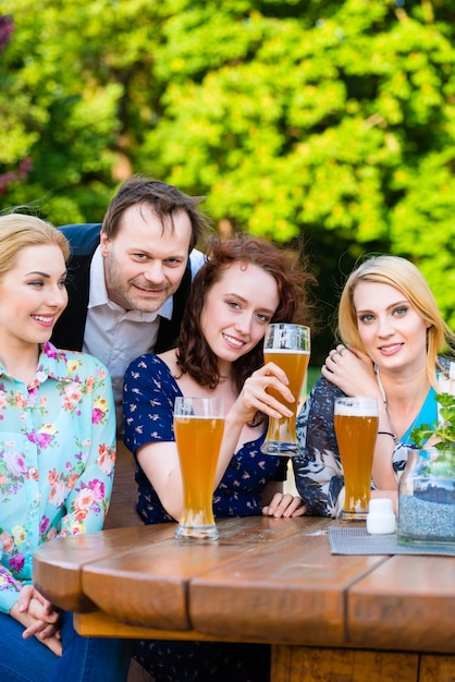 Friends sitting in beer garden restaurant