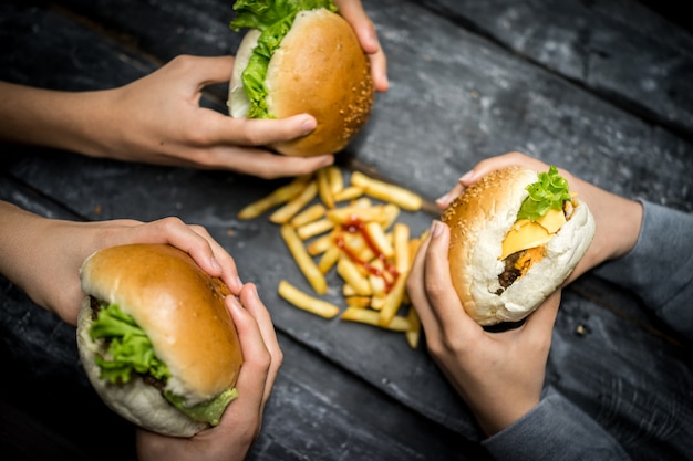 Friends sitting and eating burger