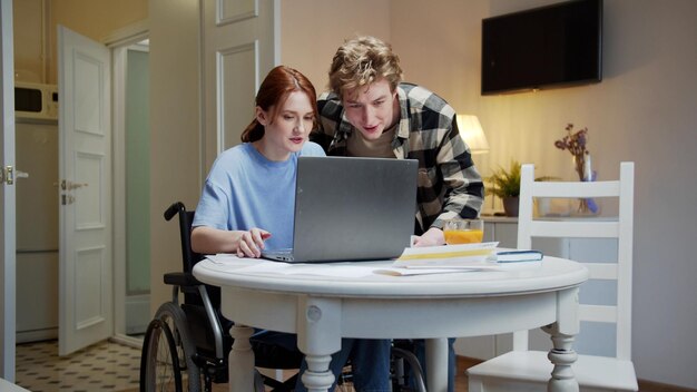 Friends sitting on table at home