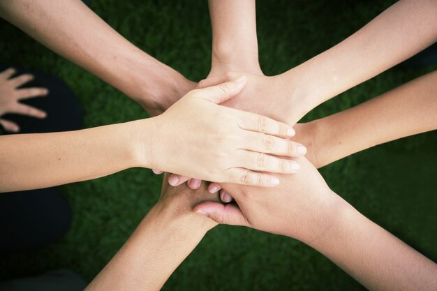 Friends stacking hands