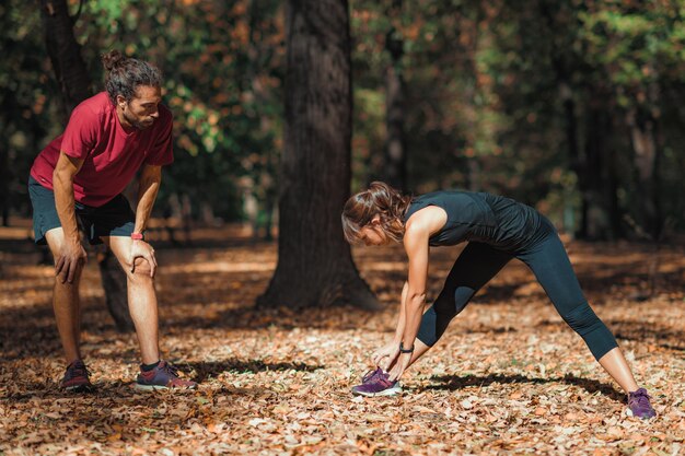 Friends stretching after training in the park