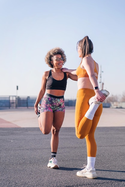 Friends stretching together in an urban park