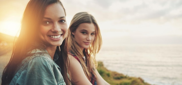 Friends at sunset women at the beach with travel and adventure portrait outdoor with nature and sea holiday Road trip mockup freedom and gen z youth on summer vacation happiness with lens flare