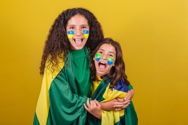 Friends supporters of Brazil soccer fans screaming goal while watching soccer game World Cup Olympics