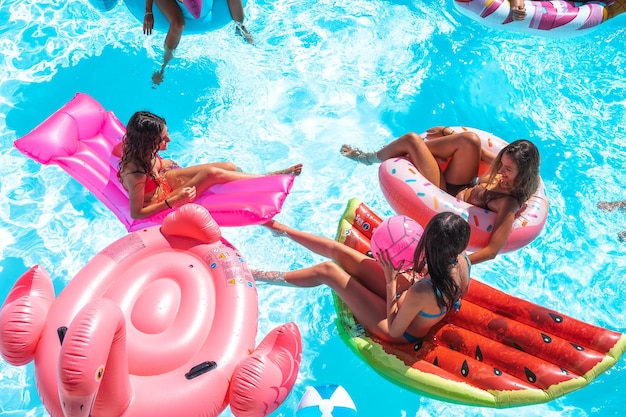 Friends in swimsuit in the pool getting a tan