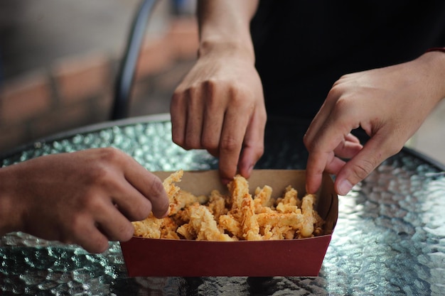 Friends take and share snacks