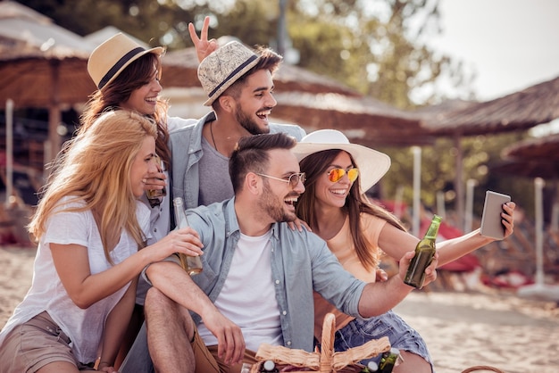 Friends taking selfie on the beach