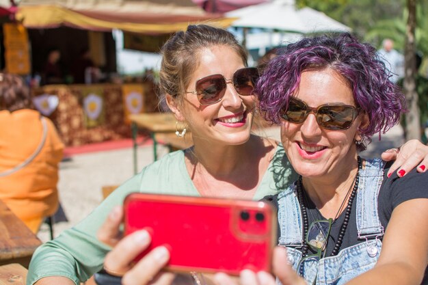 Friends taking a selfie outdoors. two smiling women taking a photo. concept of friendship.lifestyle