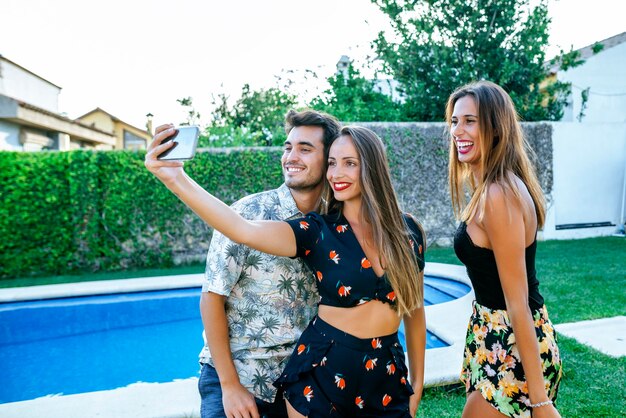 Friends taking a selfie at the poolside