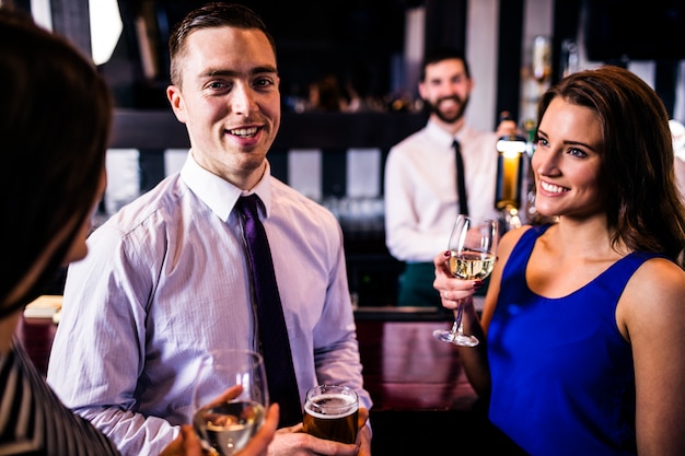 Friends talking and having a drink in a bar