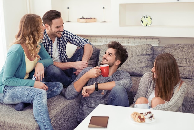 Friends talking and smiling in a house