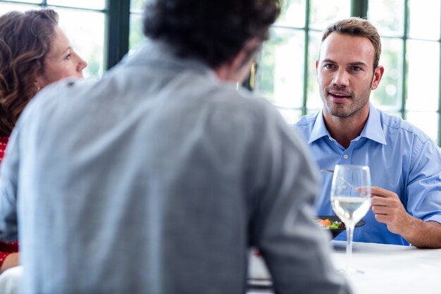 Friends talking while having lunch