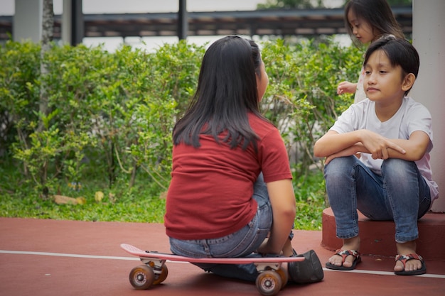 Friends talking while sitting outdoors