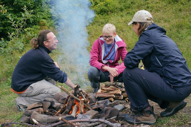 Friends traveling together and enjoy heart bonfire in camping