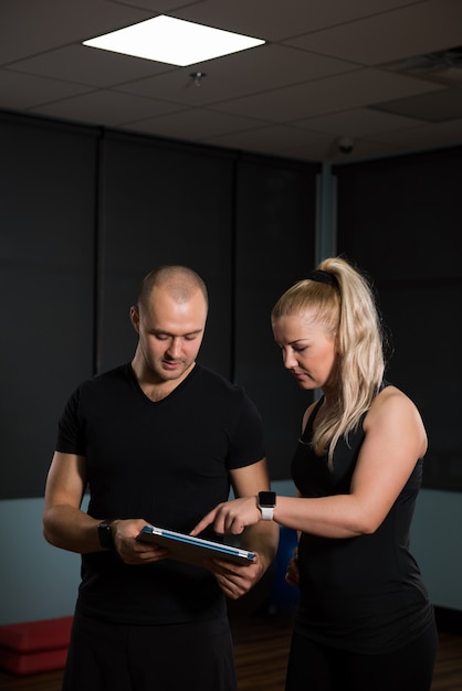 Foto amici che per mezzo della tavola digitale alla palestra